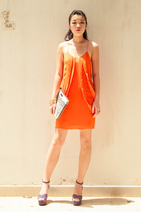 Aijek Swirl in Circles Tangerine silk dress matched with a DEBB clutch and Edge of Ember's assorted rings and bangles.