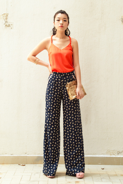 Aijek Coral Top matched with a gorgeous Palazzo pants. Completed with Edge of Ember earrings and bangles and a laser cut gold Marie Turnor picnic clutch.